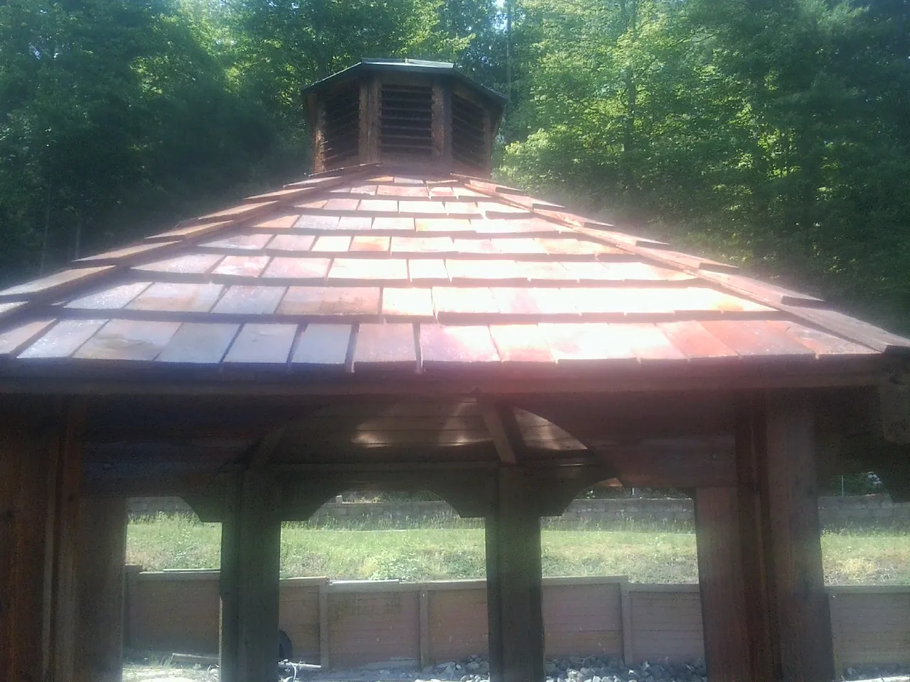 New cedar shake roof and cupola on a lakeside gazebo in North Bend